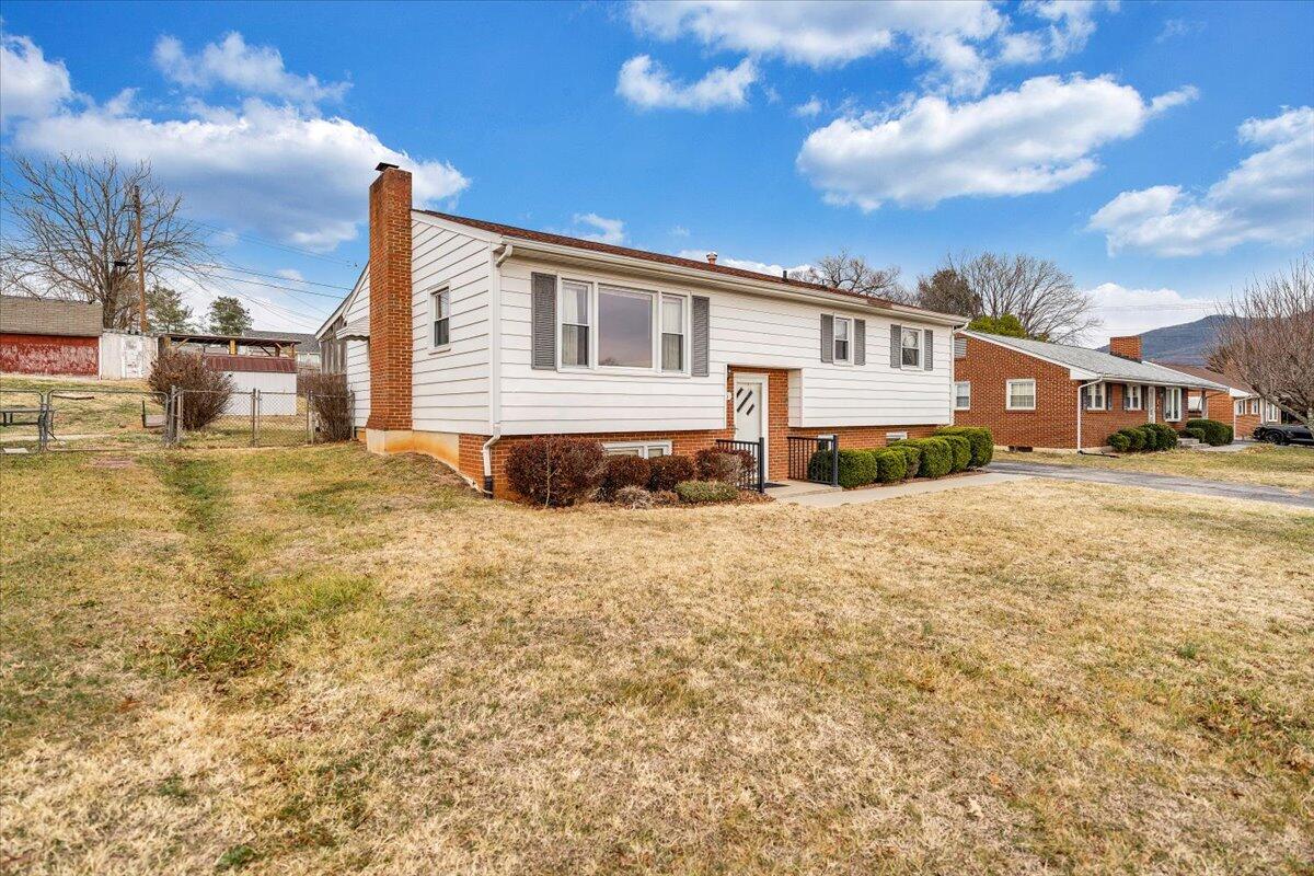 626 Santee Road Roanoke, VA 24019 - Photo 52 of 56 a front view of a house with a yard covered with snow and buildings