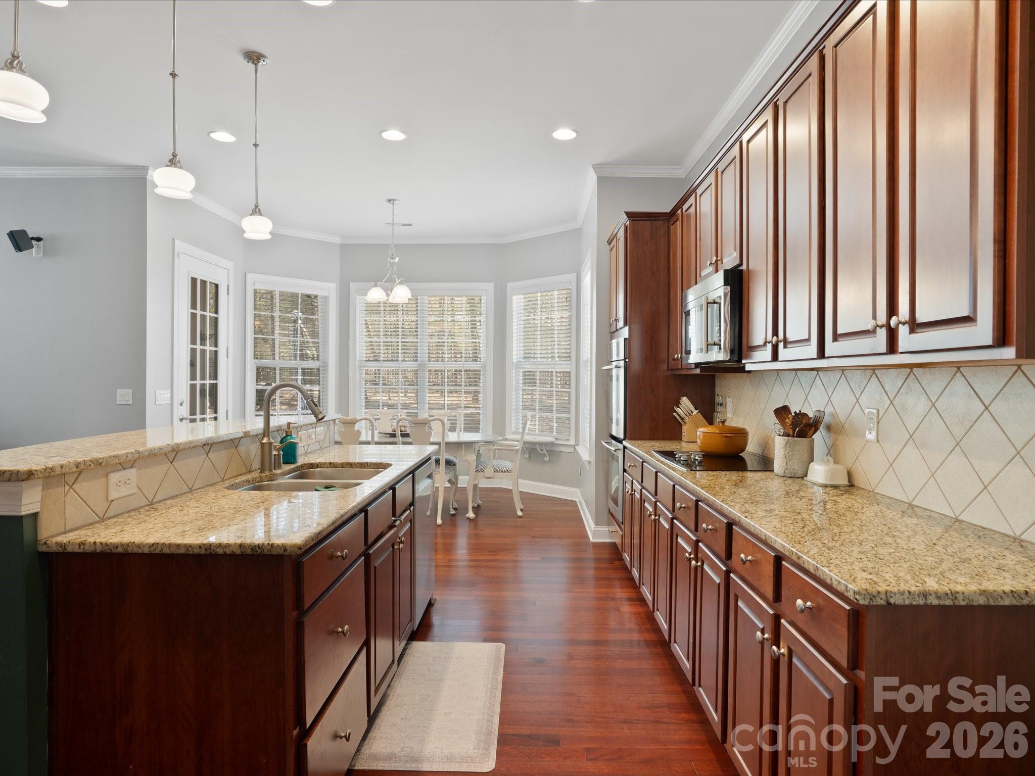 567 Quicksilver Trail Fort Mill, SC 29708 - Photo 14 of 37 a kitchen with kitchen island granite countertop a sink stove and cabinets
