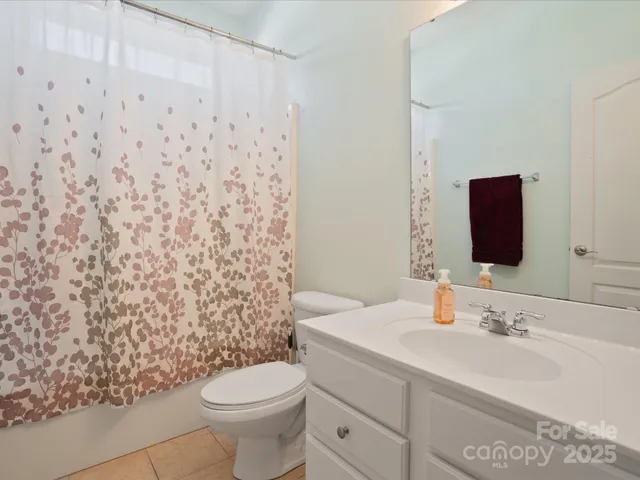 a bathroom with a sink toilet and mirror