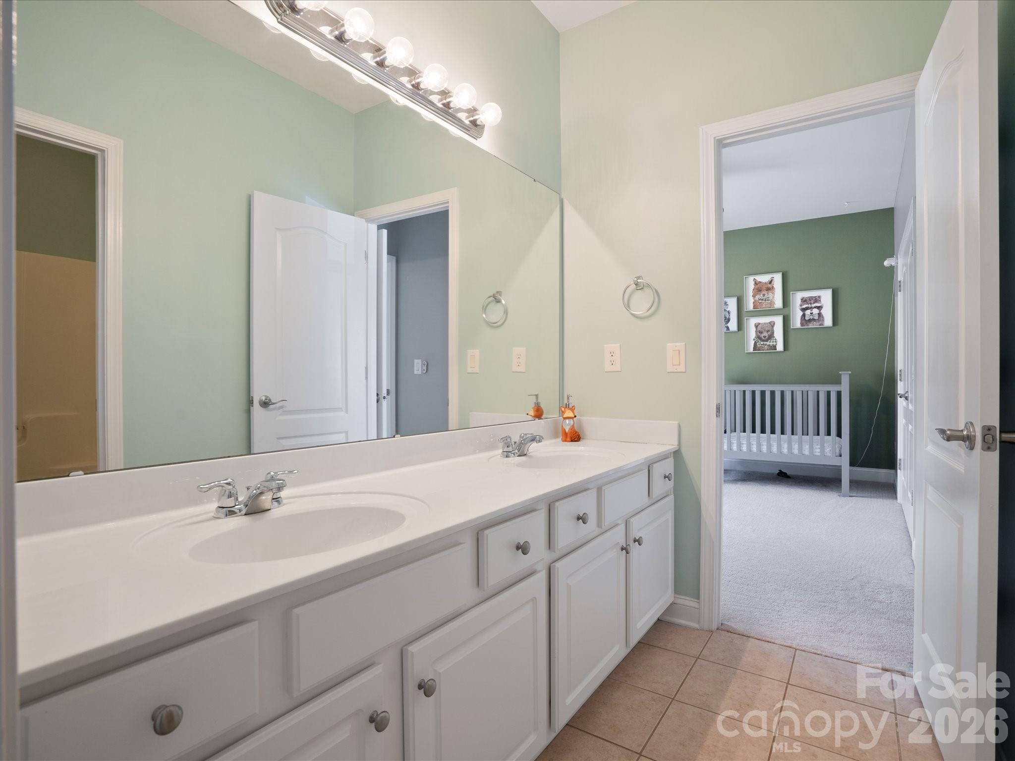 567 Quicksilver Trail Fort Mill, SC 29708 - Photo 21 of 37 a en suite bathroom with a double vanity sink and a mirror