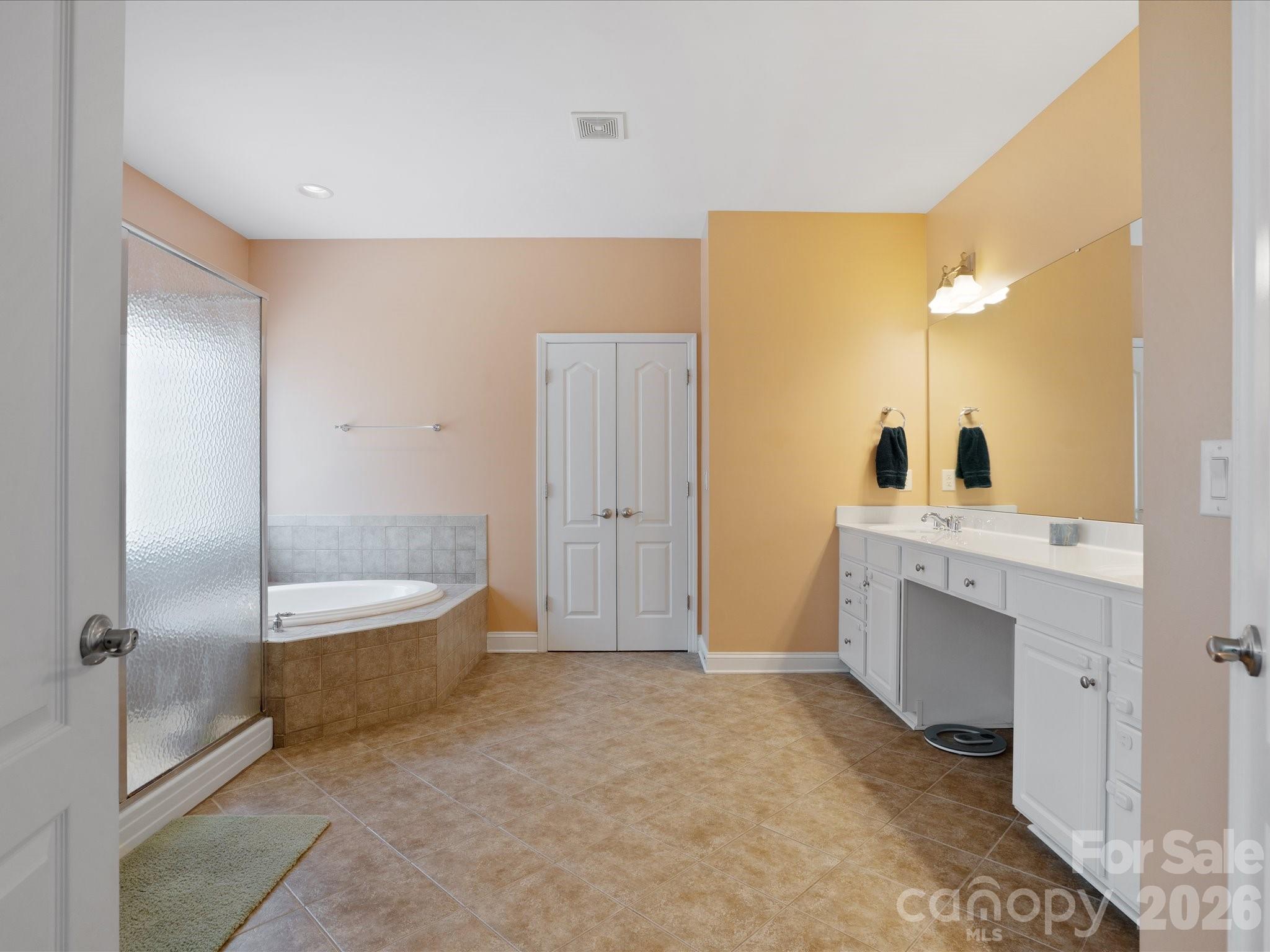 567 Quicksilver Trail Fort Mill, SC 29708 - Photo 24 of 37 a spacious bathroom with a tub sink and mirror