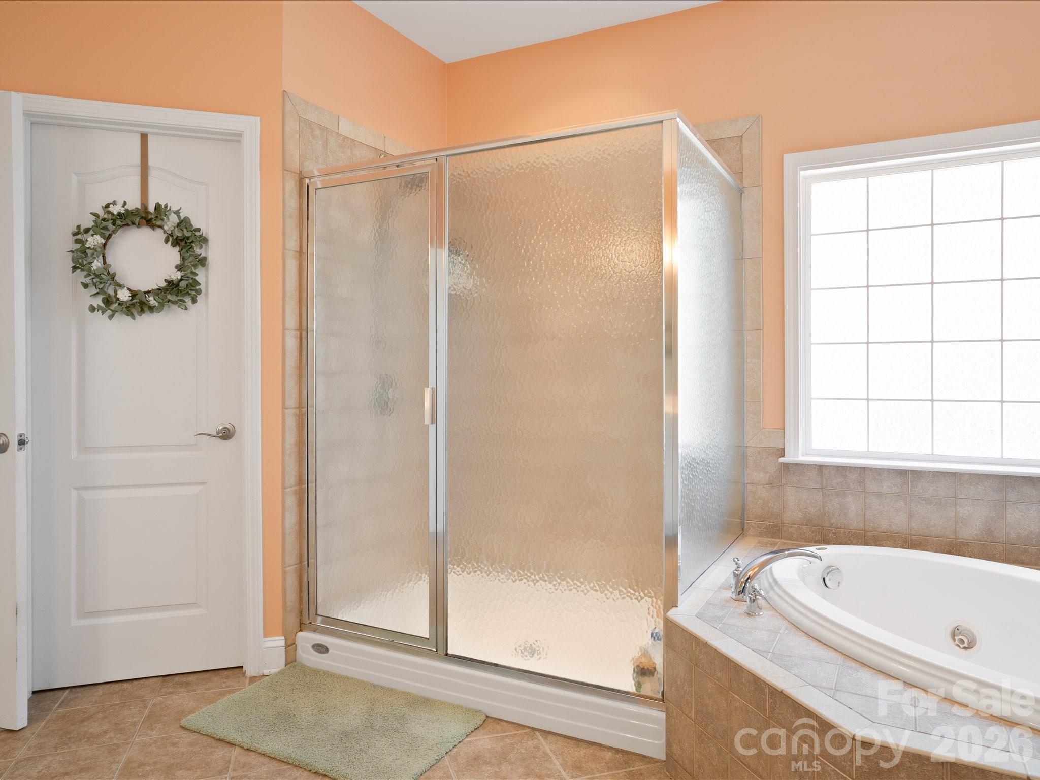 567 Quicksilver Trail Fort Mill, SC 29708 - Photo 26 of 37 a bathroom with a tub and shower