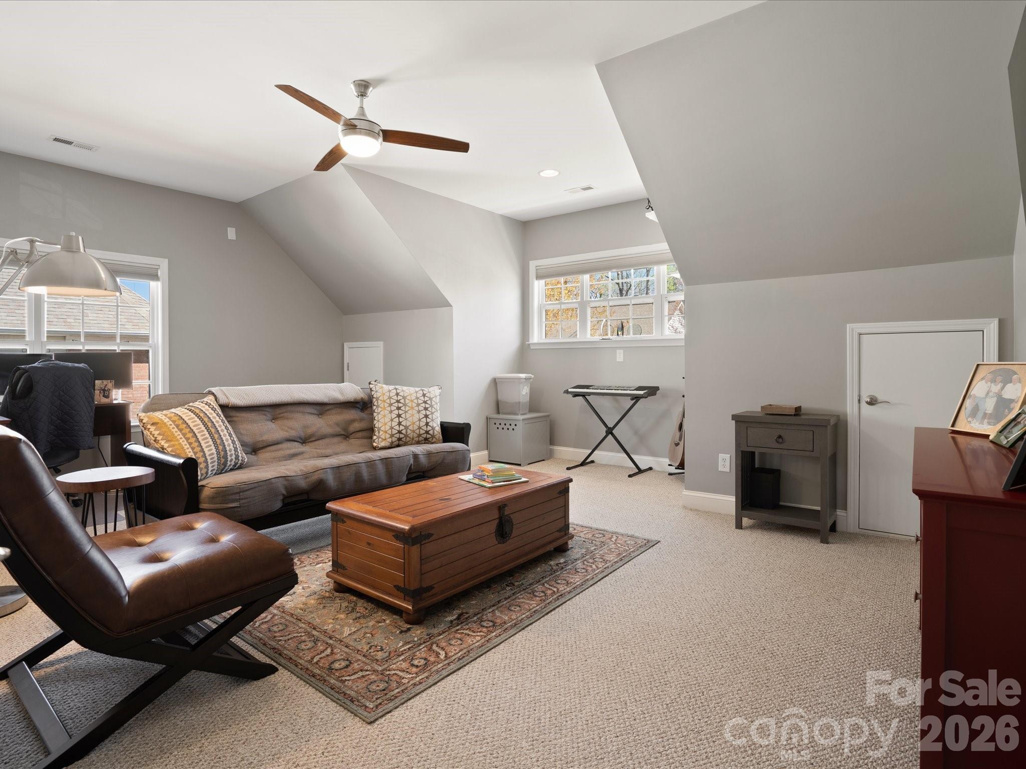 567 Quicksilver Trail Fort Mill, SC 29708 - Photo 28 of 37 a living room with furniture a ceiling fan and a rug