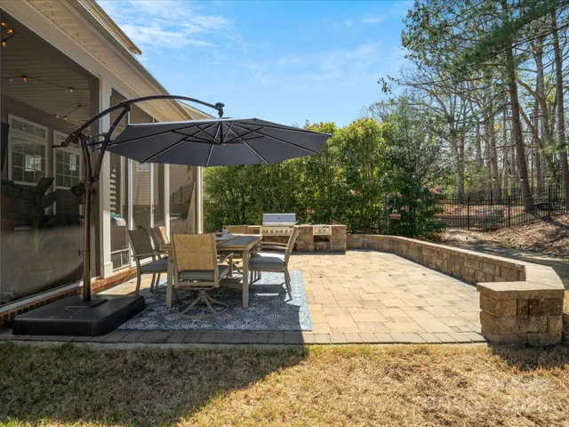 a front view of a house with a yard fire pit and outdoor seating