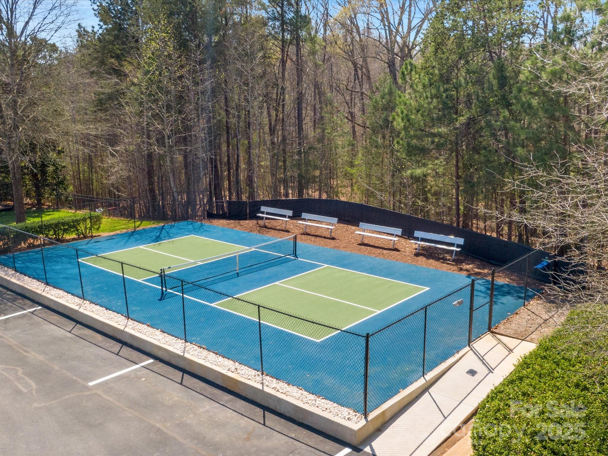 567 Quicksilver Trail Fort Mill, SC 29708 - Photo 34 of 37 a view of a tennis ground with large trees