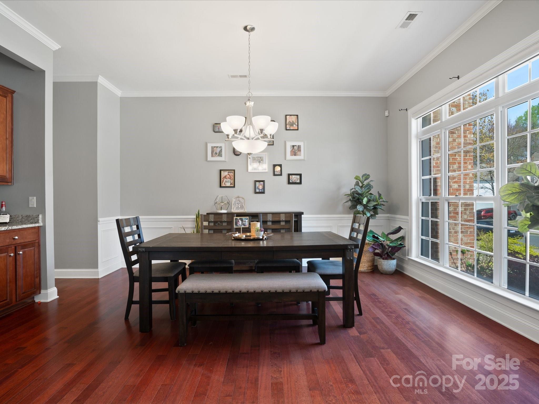 567 Quicksilver Trail Fort Mill, SC 29708 - Photo 6 of 37 a view of a dining room with furniture wooden floor and chandelier