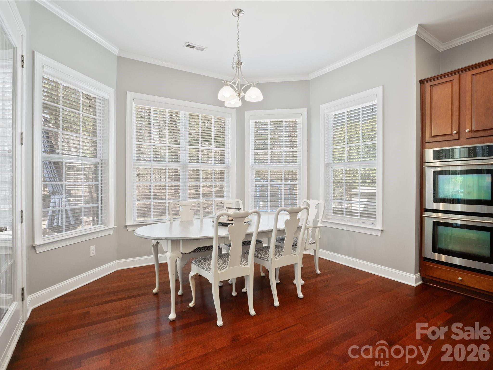 567 Quicksilver Trail Fort Mill, SC 29708 - Photo 9 of 37 a view of a dining room with furniture windows and wooden floor