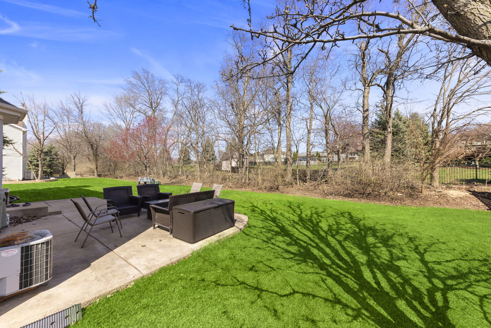 1934 Raintree Road Yorkville, IL 60560 - Photo 33 of 40 a view of backyard with table and chairs and wooden fence