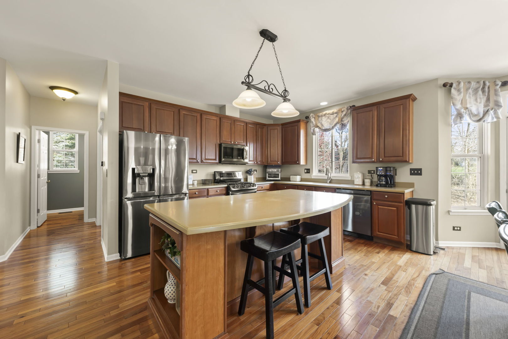 1934 Raintree Road Yorkville, IL 60560 - Photo 8 of 40 a kitchen with stainless steel appliances granite countertop a refrigerator a stove top oven a sink dishwasher and white cabinets with wooden floor