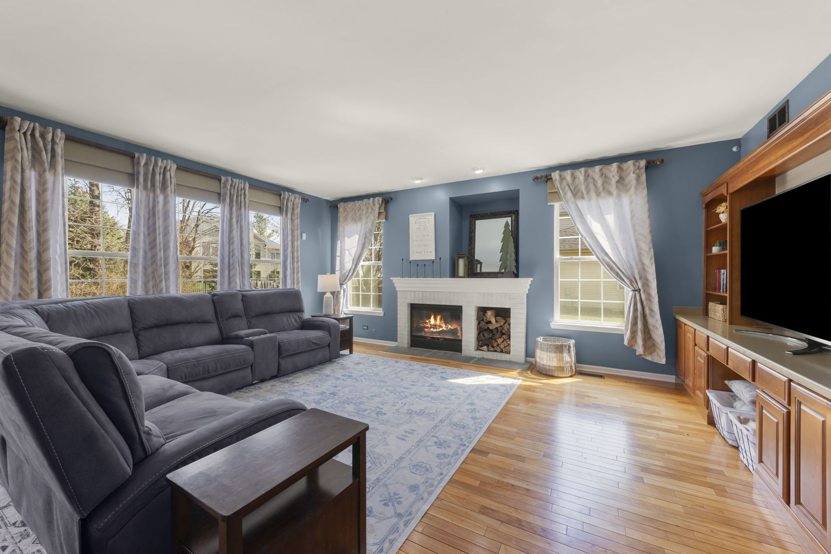 1934 Raintree Road Yorkville, IL 60560 - Photo 10 of 40 a living room with furniture a flat screen tv and a fireplace