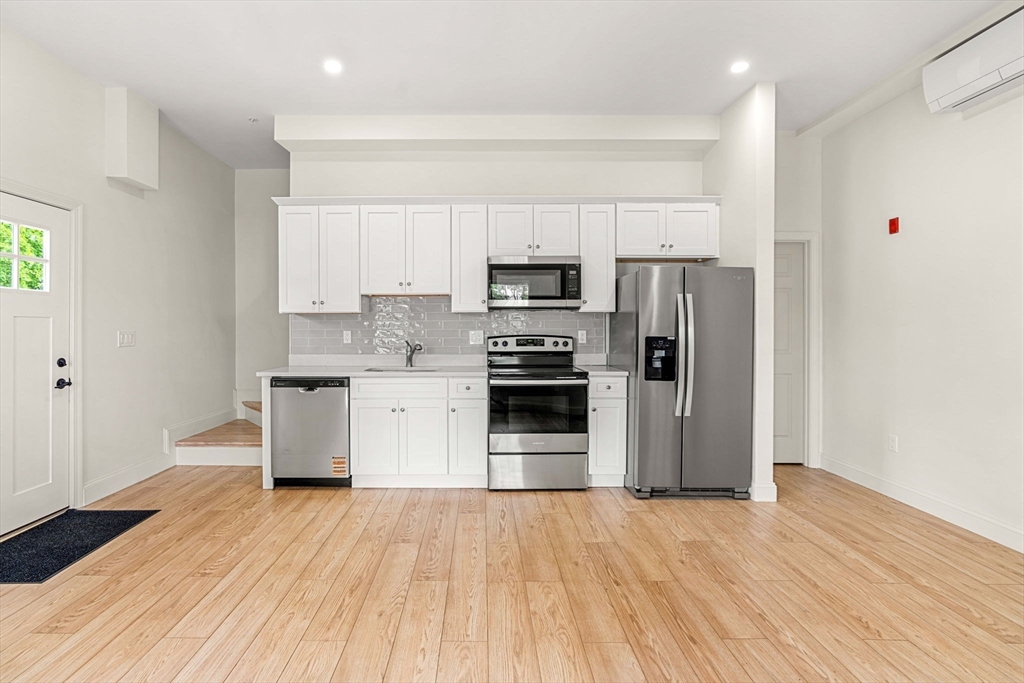 1280 Middlesex Street Lowell, MA 01851 - Photo 11 of 35 a kitchen with stainless steel appliances a refrigerator and a stove top oven