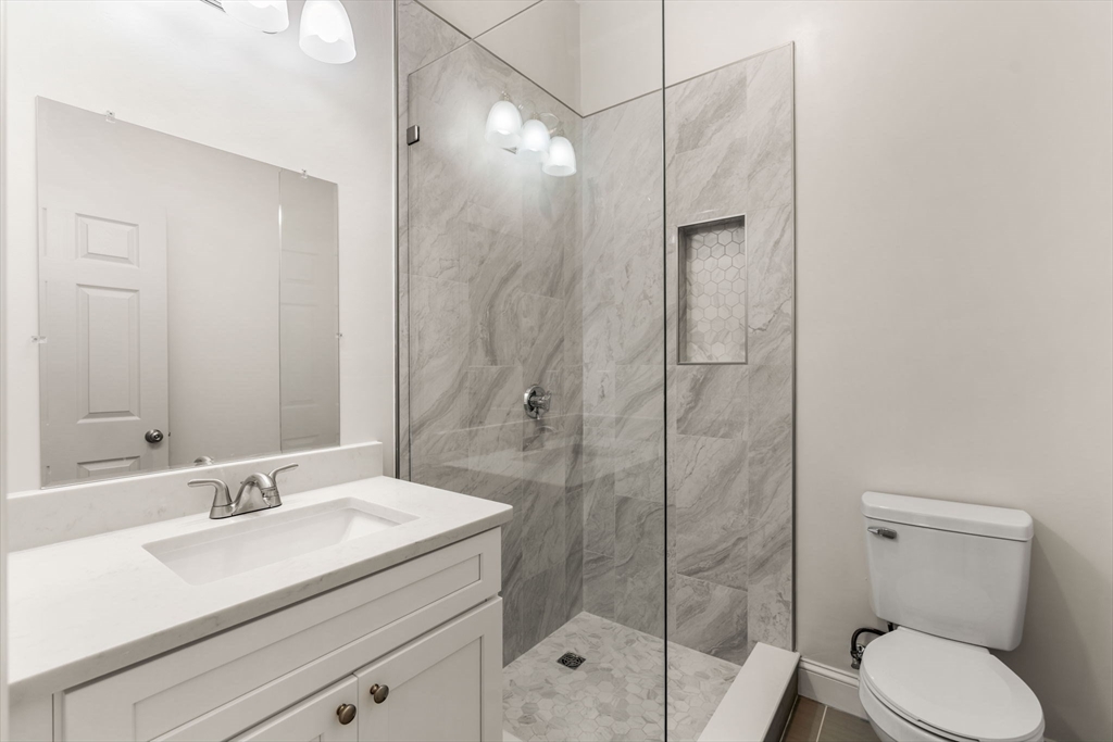 1280 Middlesex Street Lowell, MA 01851 - Photo 16 of 35 a bathroom with a granite countertop sink toilet and shower