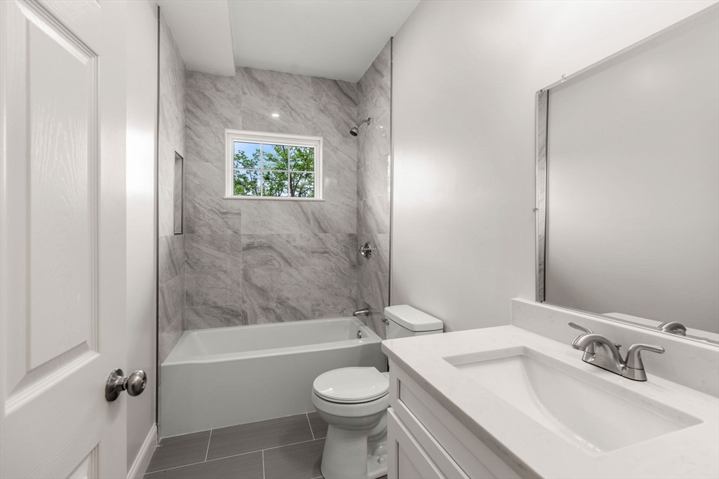 1280 Middlesex Street Lowell, MA 01851 - Photo 19 of 35 a bathroom with a sink a toilet and shower