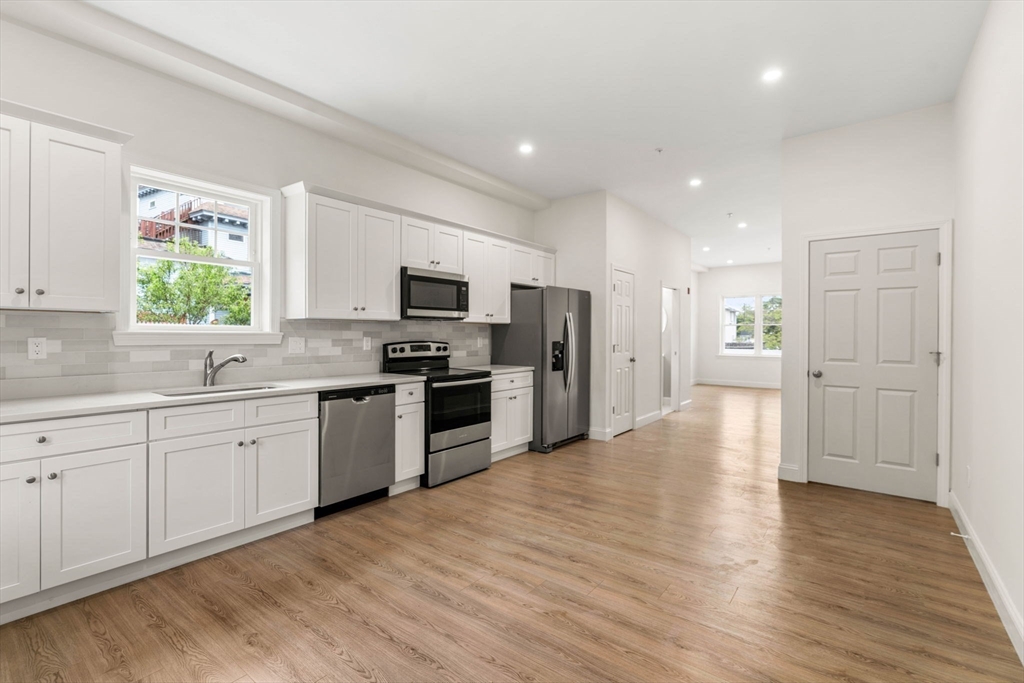 1280 Middlesex Street Lowell, MA 01851 - Photo 22 of 35 a kitchen with a refrigerator and a stove top oven