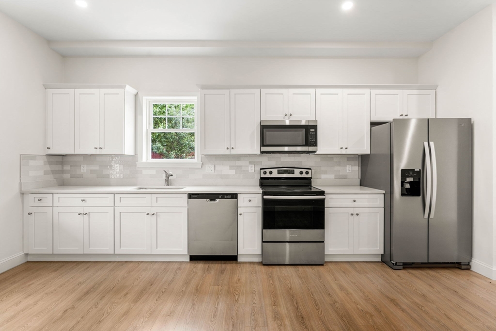 1280 Middlesex Street Lowell, MA 01851 - Photo 23 of 35 a kitchen with a refrigerator stove and microwave