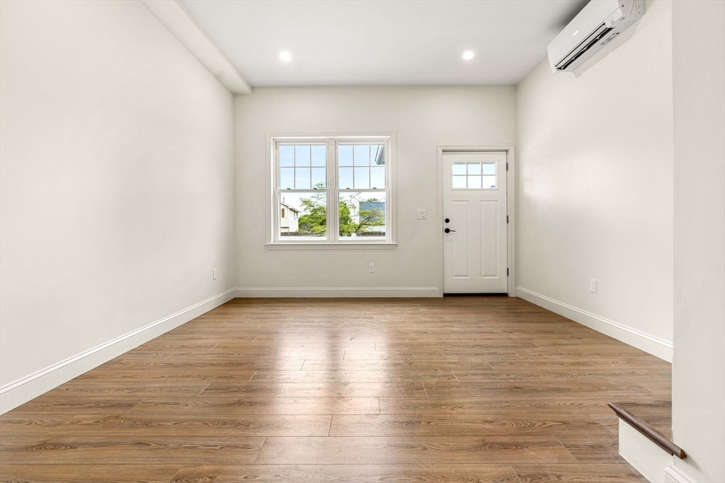 1280 Middlesex Street Lowell, MA 01851 - Photo 25 of 35 an empty room with wooden floor and windows