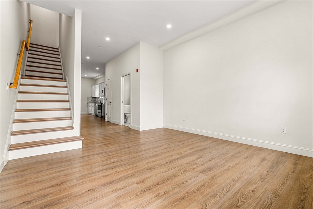 1280 Middlesex Street Lowell, MA 01851 - Photo 26 of 35 a view of a room with wooden floor and stairs