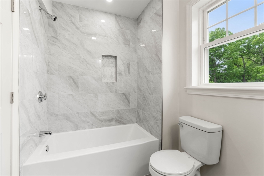 1280 Middlesex Street Lowell, MA 01851 - Photo 28 of 35 a bathroom with a toilet and a bathtub