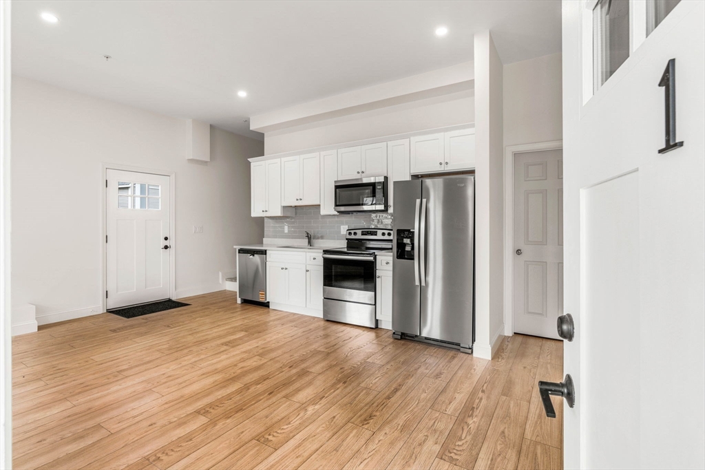 1280 Middlesex Street Lowell, MA 01851 - Photo 4 of 35 a view of kitchen view wooden floor and electronic appliances