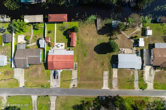 an aerial view of residential houses with outdoor space and swimming pool