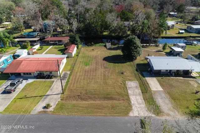 an aerial view of residential houses with outdoor space and street view