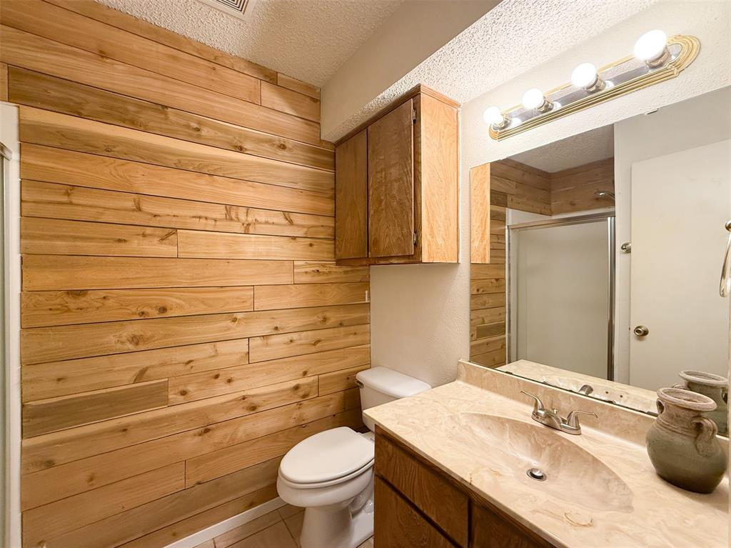 1237 Dallas Drive Denton, TX 76205 - Photo 11 of 18 a bathroom with a sink a toilet and shower