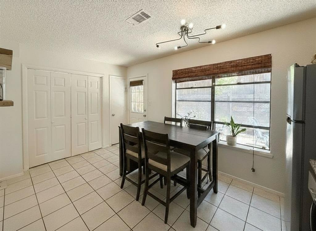 1237 Dallas Drive Denton, TX 76205 - Photo 4 of 18 a view of a dining room with furniture and window