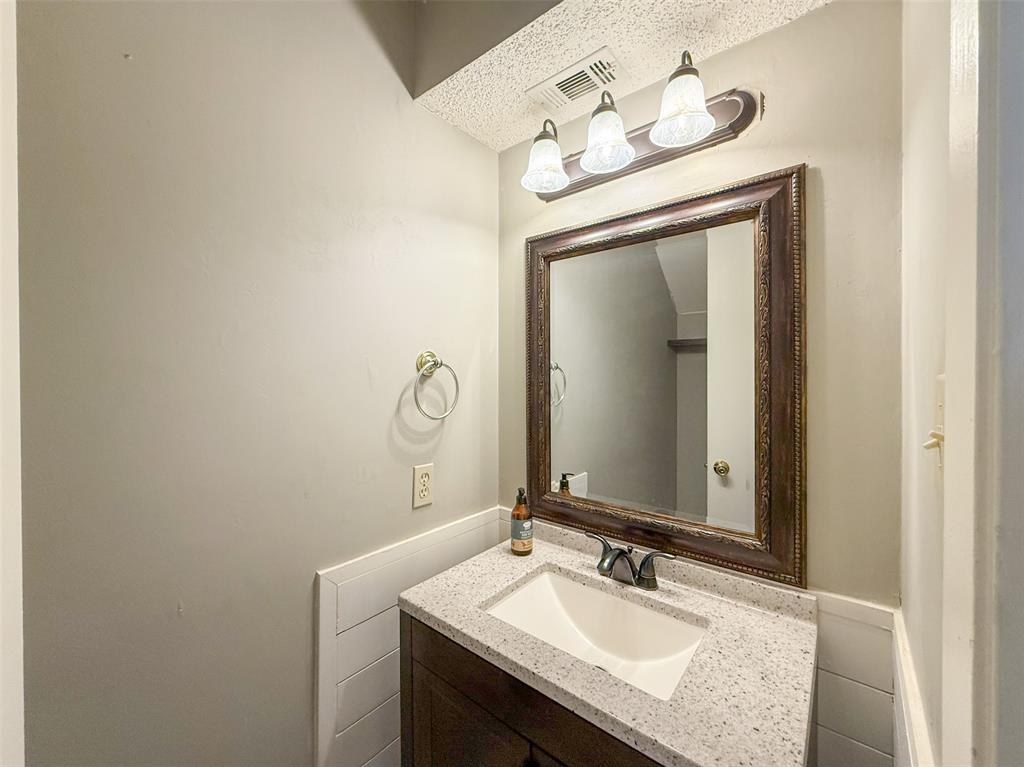 1237 Dallas Drive Denton, TX 76205 - Photo 5 of 18 a bathroom with a sink vanity and a mirror