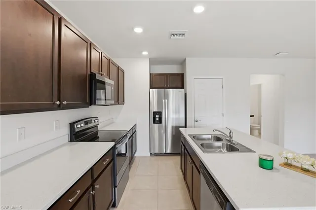 a kitchen with a sink a stove and a refrigerator