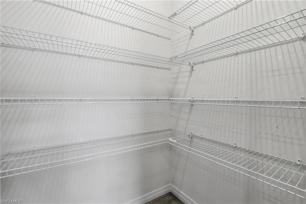 15368 Wildflower Circle Naples, FL 34119 - Photo 15 of 35 a view of a room with racks on the wall