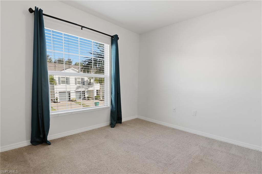 15368 Wildflower Circle Naples, FL 34119 - Photo 22 of 35 a view of an empty room with a window