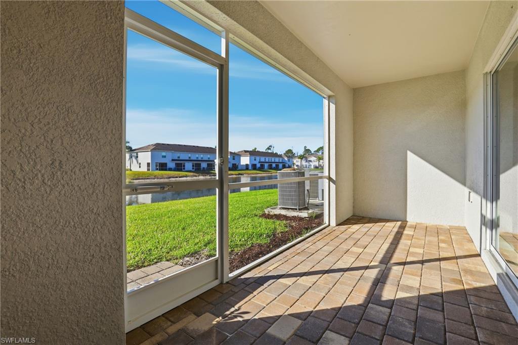 15368 Wildflower Circle Naples, FL 34119 - Photo 26 of 35 a view of a bedroom with wooden floor and city view