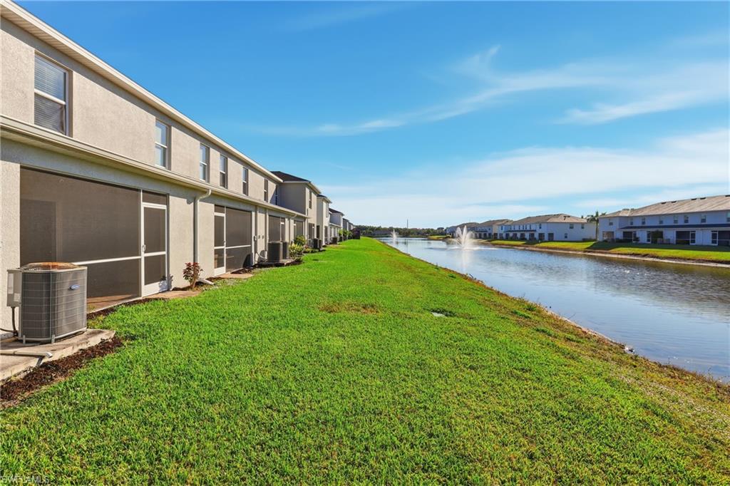 15368 Wildflower Circle Naples, FL 34119 - Photo 27 of 35 a view of a house with pool and a yard