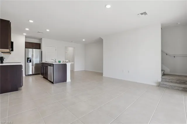 a view of kitchen with stainless steel appliances a refrigerator and a stove top oven