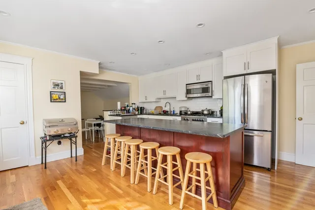 a kitchen with stainless steel appliances granite countertop a refrigerator and a stove top oven