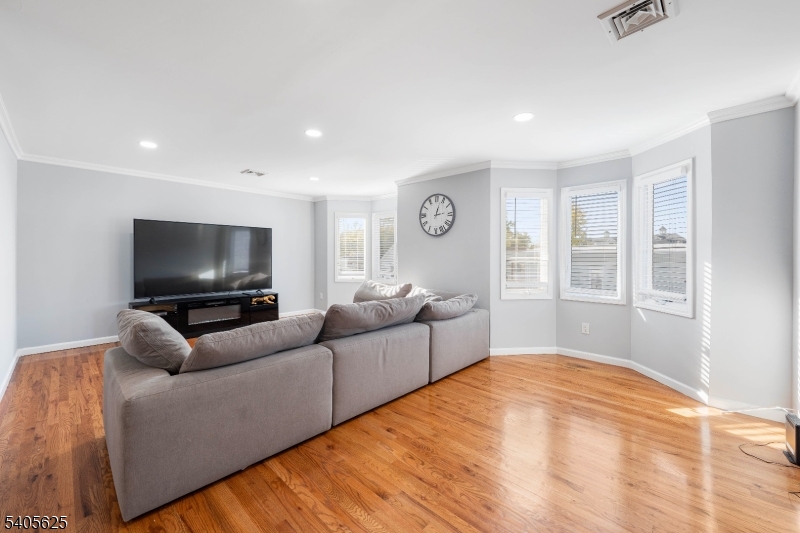 118 Race Street, Unit 2 Elizabeth, NJ 07202 - Photo 12 of 16 a living room with furniture and a flat screen tv