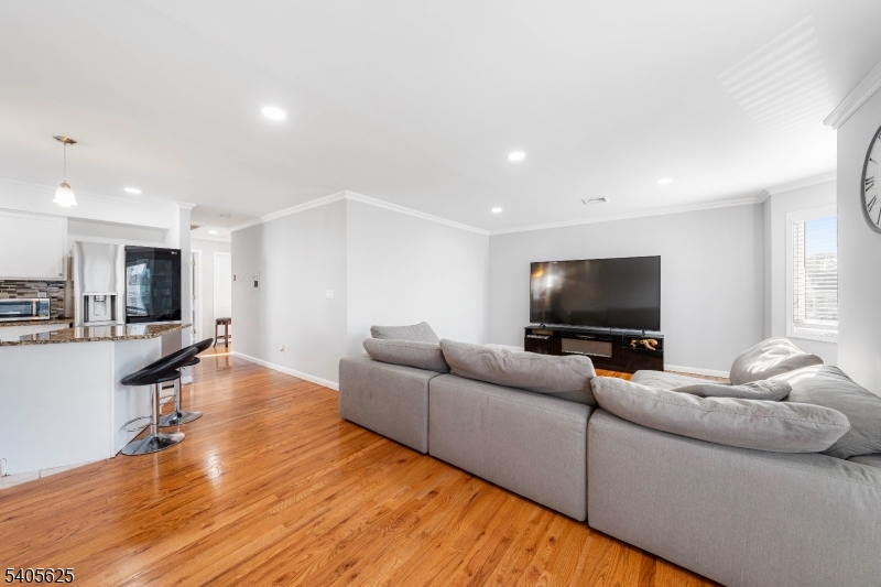 118 Race Street, Unit 2 Elizabeth, NJ 07202 - Photo 15 of 16 a living room with furniture and a flat screen tv
