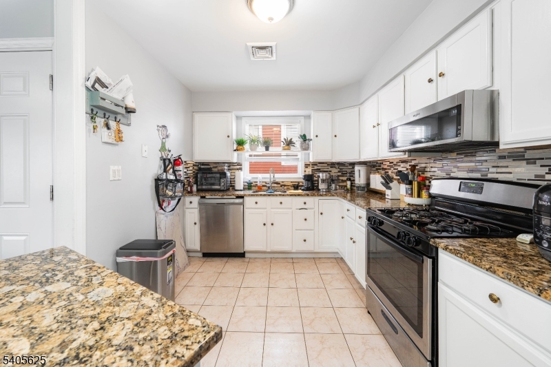 118 Race Street, Unit 2 Elizabeth, NJ 07202 - Photo 4 of 16 a kitchen with a stove a sink and a refrigerator