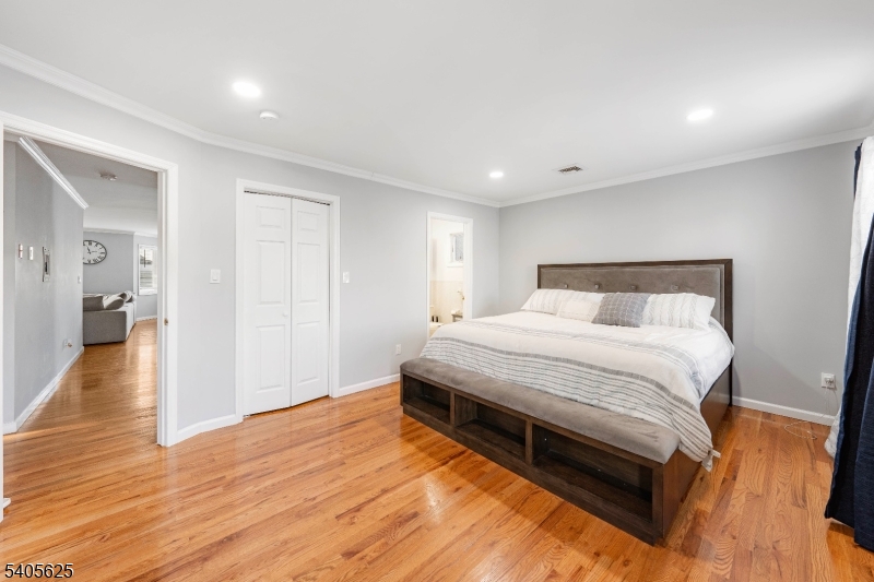 118 Race Street, Unit 2 Elizabeth, NJ 07202 - Photo 7 of 16 a spacious bedroom with a bed and wooden floor