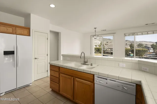 a kitchen with granite countertop a stove sink and cabinets