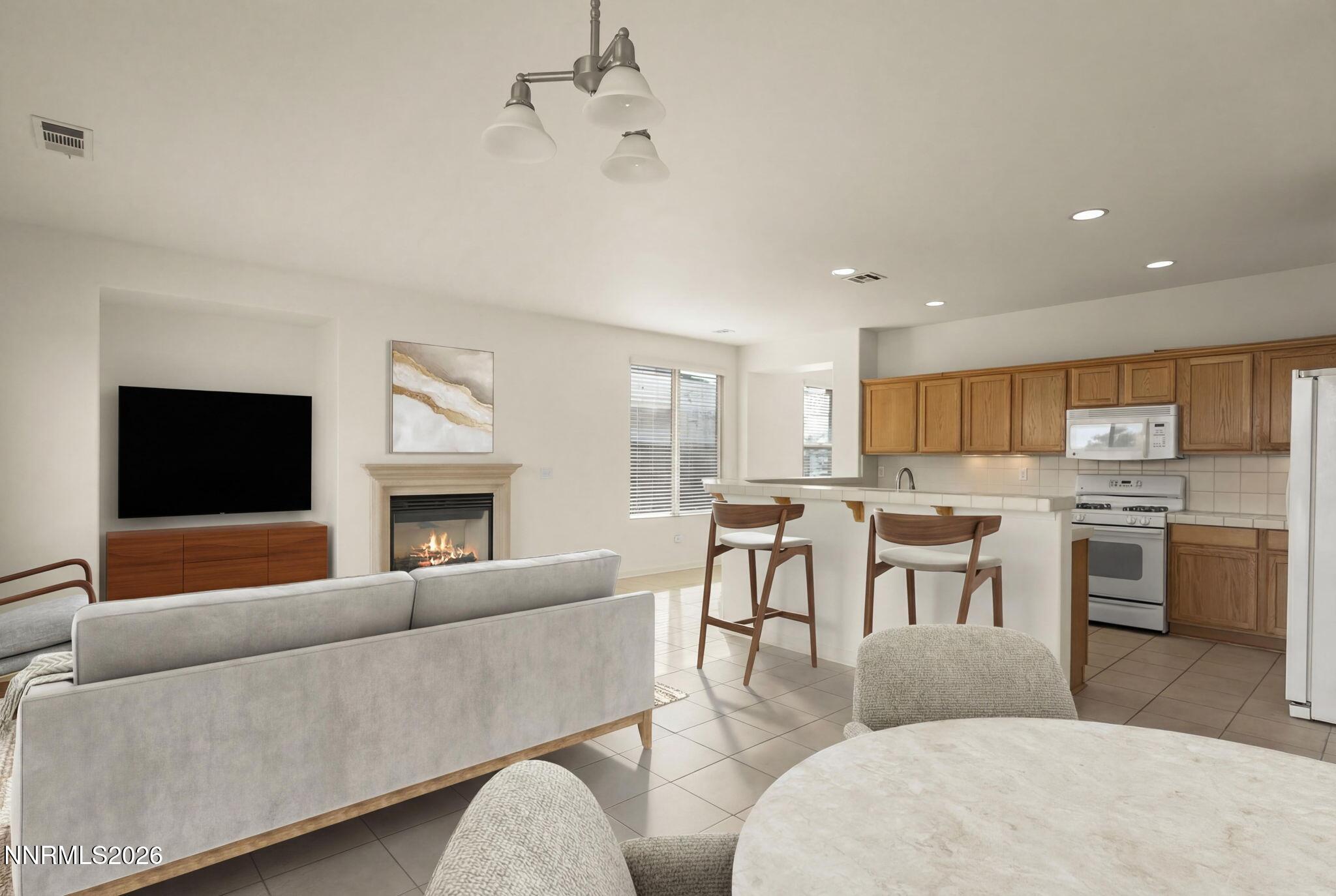 1710 Autumn Valley Way Reno, NV 89523 - Photo 4 of 25 a living room with furniture kitchen view and a fireplace