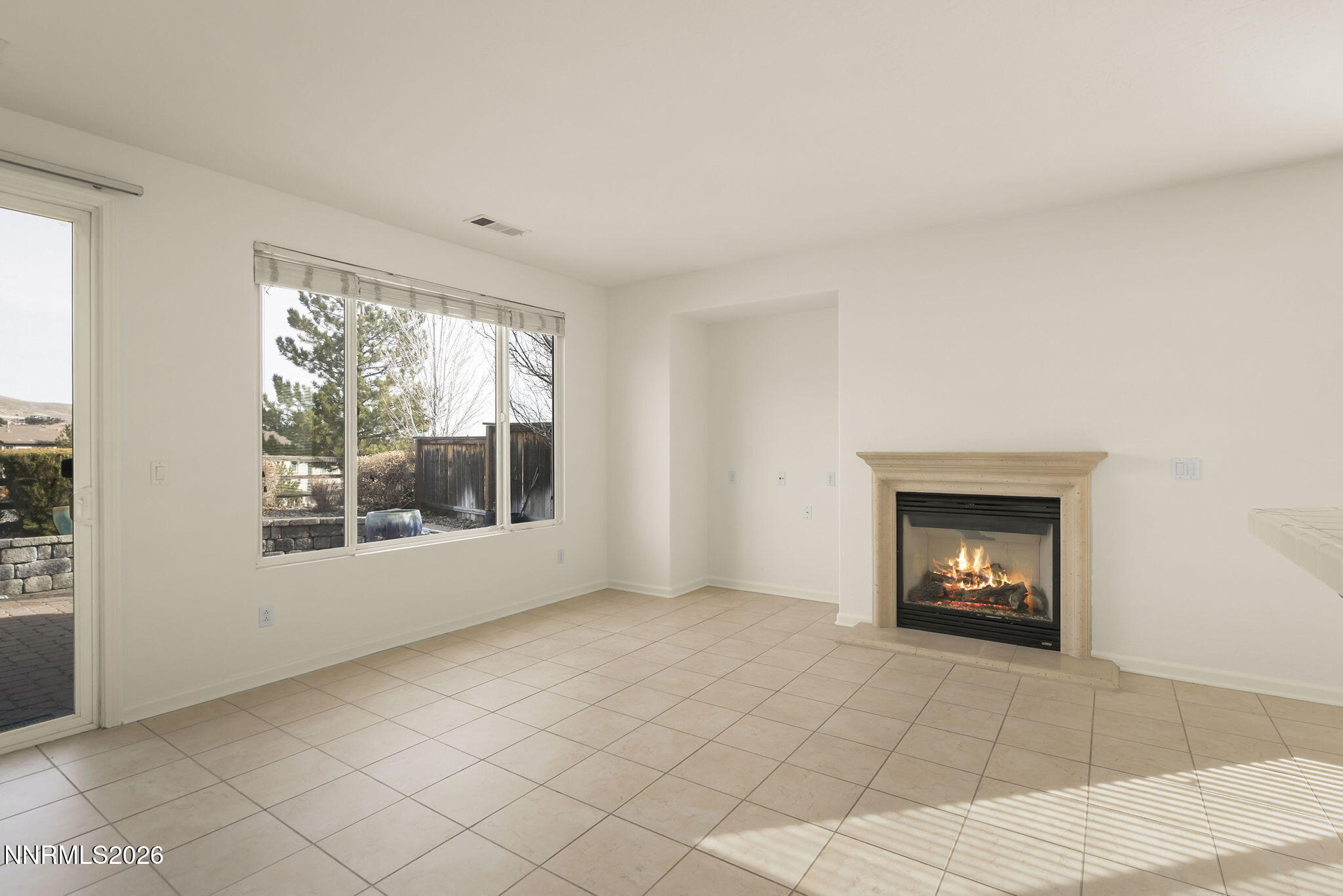 1710 Autumn Valley Way Reno, NV 89523 - Photo 6 of 25 a view of an empty room with a window and fire place