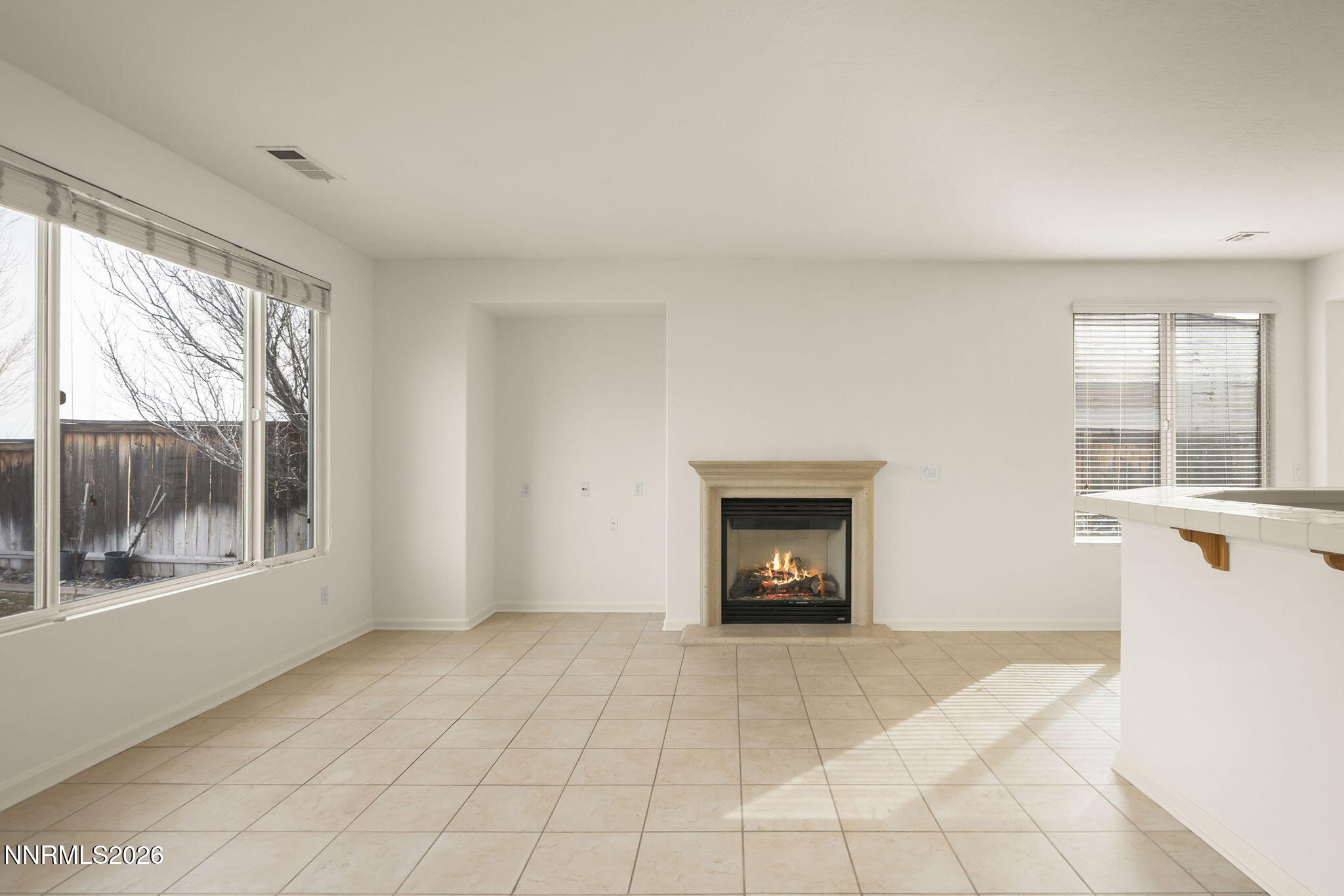 1710 Autumn Valley Way Reno, NV 89523 - Photo 7 of 25 a view of an empty room with a fireplace and a window