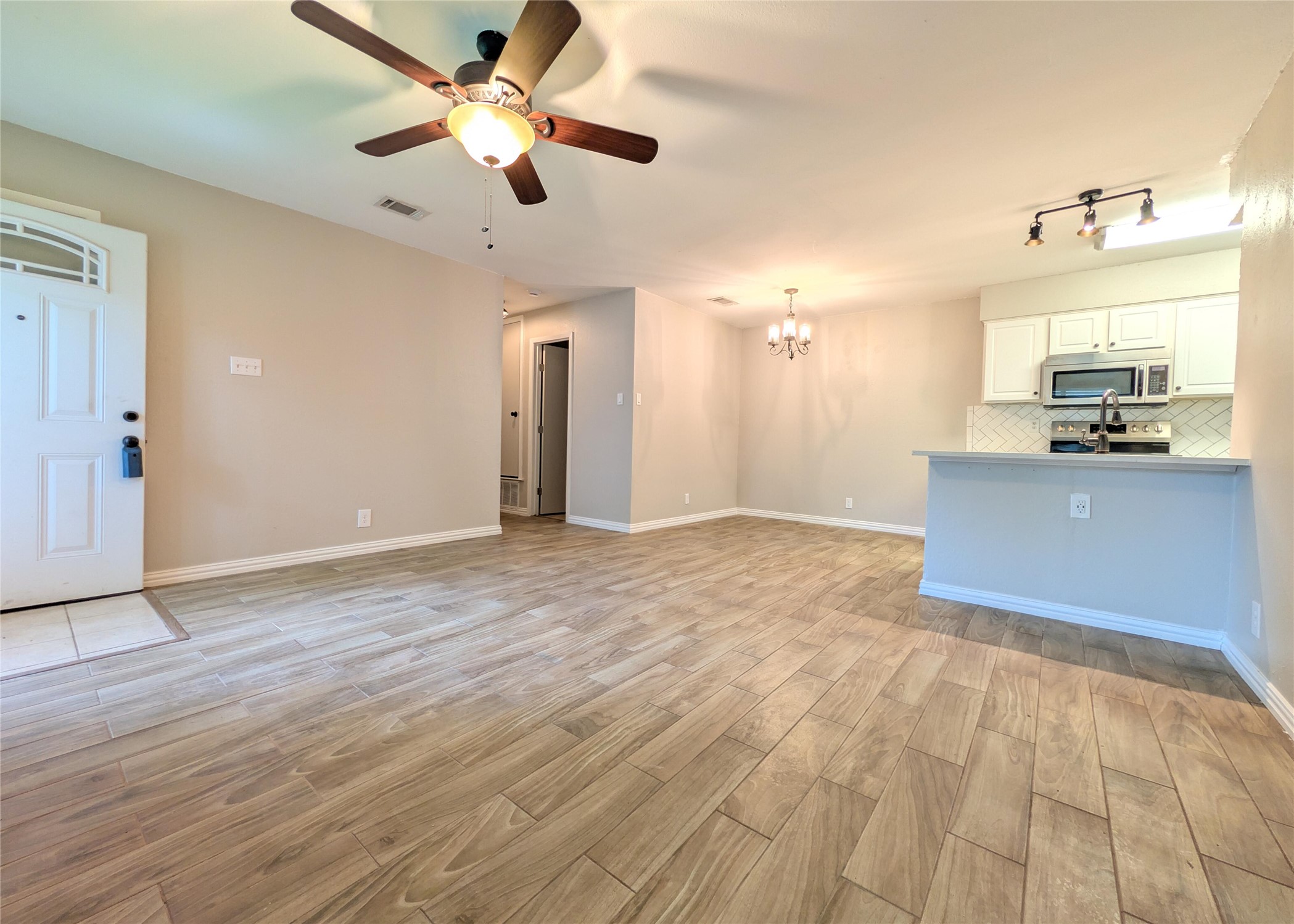 12601 Turtle Rock Road, Unit B Austin, TX 78729 - Photo 19 of 20 Entry into the Living Room, Dining Room, Kitchen open floor plan area.