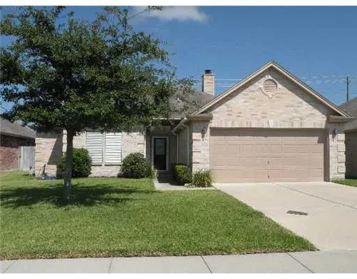 a view of a house with a yard and garage