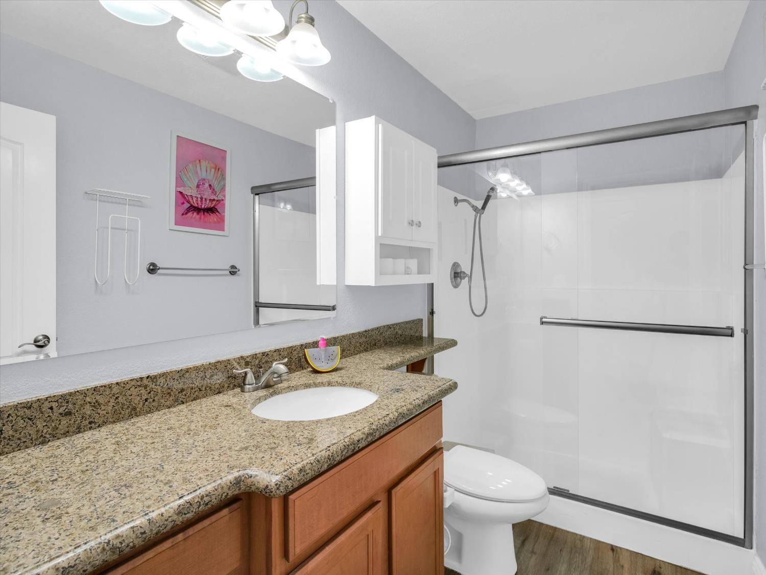 1177 Norwegian Avenue, Unit 8 Modesto, CA 95350 - Photo 12 of 28 a bathroom with a granite countertop shower sink vanity mirror and toilet