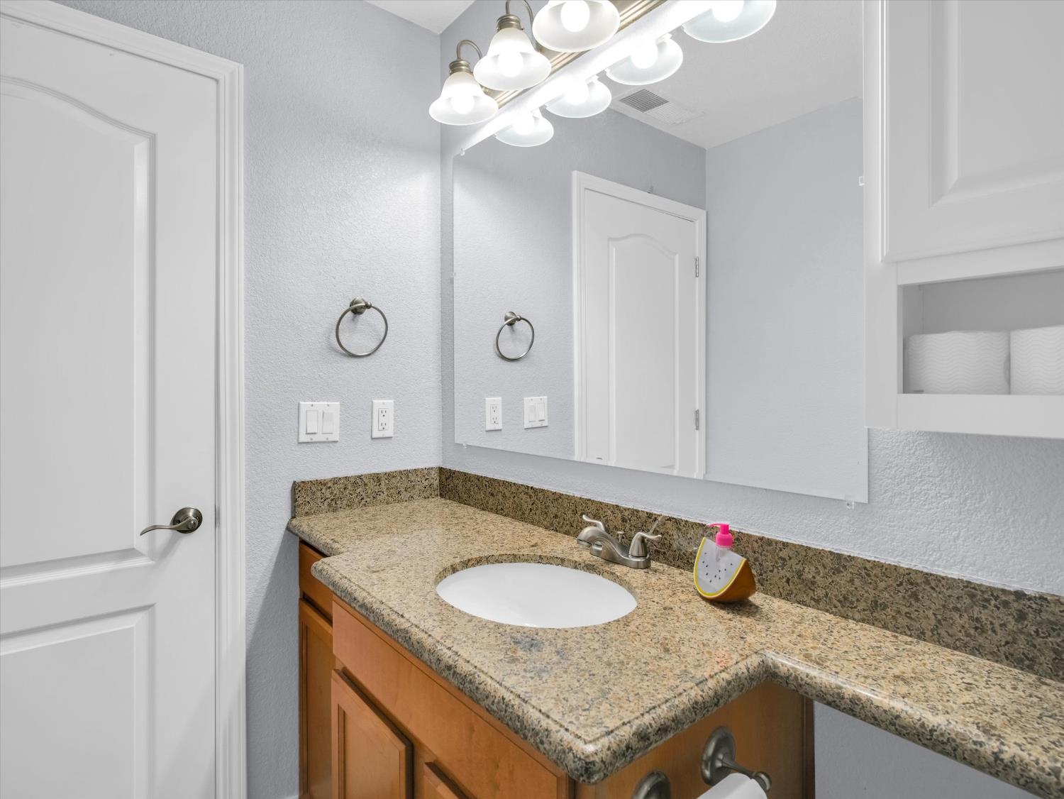 1177 Norwegian Avenue, Unit 8 Modesto, CA 95350 - Photo 13 of 28 a bathroom with a granite countertop sink a mirror and a shower