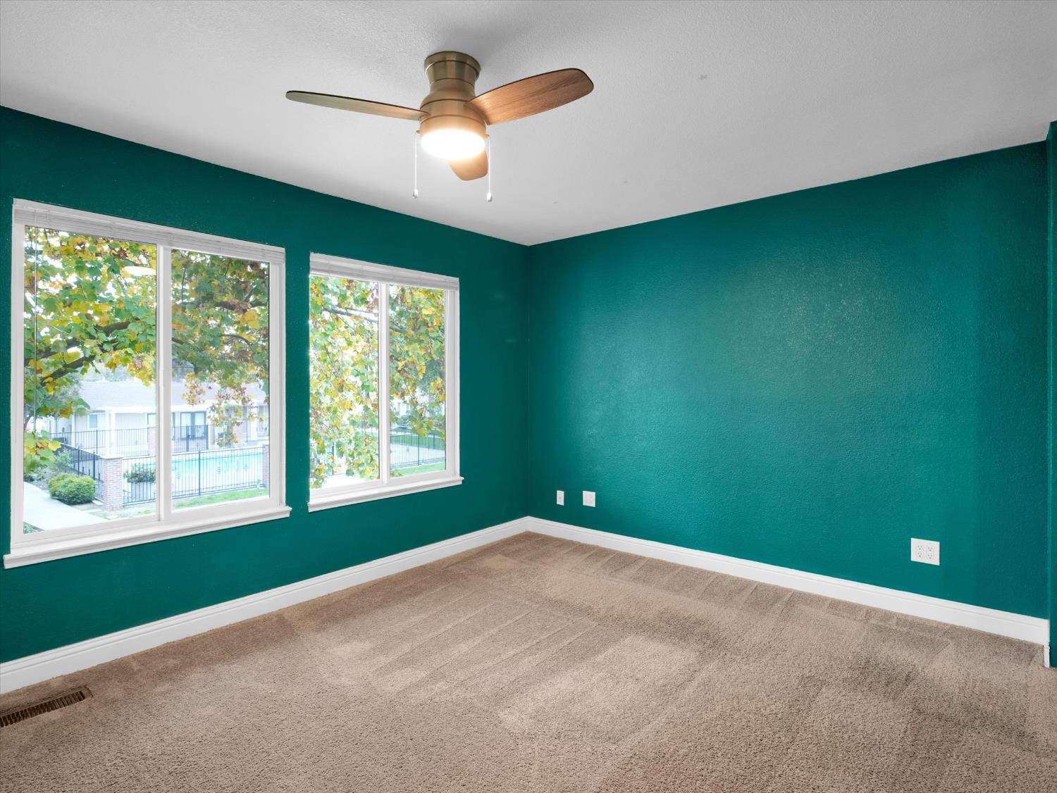 1177 Norwegian Avenue, Unit 8 Modesto, CA 95350 - Photo 19 of 28 a view of a big room with windows and chandelier fan
