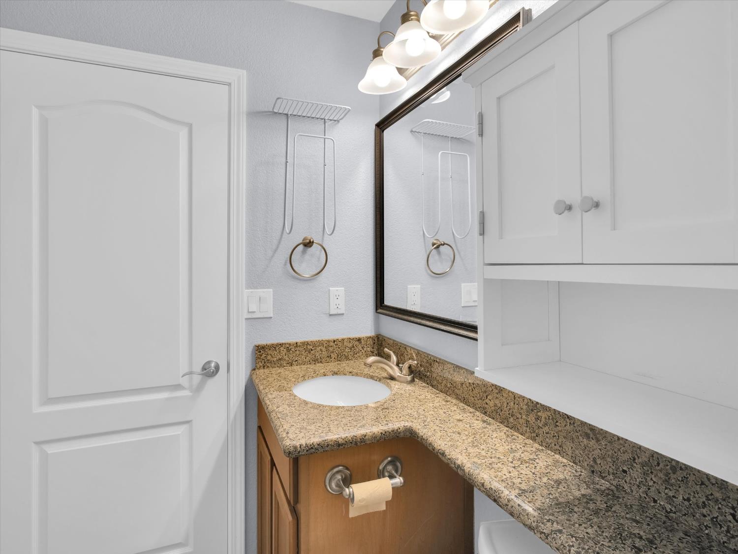 1177 Norwegian Avenue, Unit 8 Modesto, CA 95350 - Photo 22 of 28 a bathroom with a granite countertop sink and a mirror