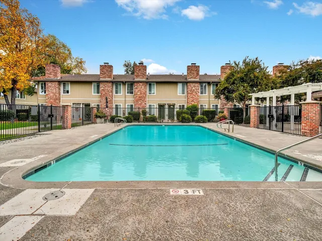 a front view of a house with a yard and table and chairs